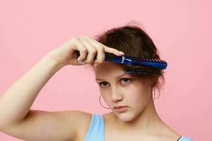 teenager girl in blue t-shirts comb with hair emotions isolated background unaltered photo