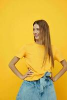 cheerful girl with long hair in denim shorts and a t-shirt photo