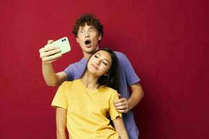 nice guy and girl in colorful T-shirts with a phone Youth style photo