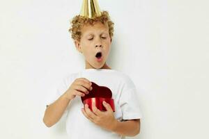 little boy wearing a white t-shirt with a cap on his head birthday gift photo