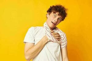 Young curly-haired man striped t shirt posing summer clothing Lifestyle unaltered photo