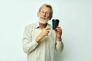 Photo of retired old man with a gray beard in a shirt and glasses light background