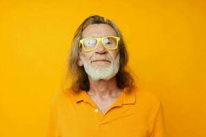 Senior grey-haired man in yellow glasses with a gray beard emotions isolated background photo