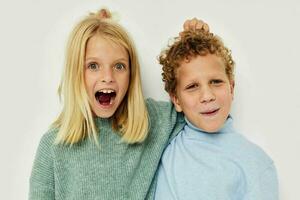 Boy and girl in multi-colored sweaters posing for fun Lifestyle unaltered photo