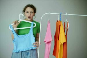 funny girl trying on clothes wardrobe Youth style isolated backgrounds unaltered photo