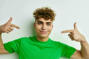 handsome guy in green t-shirts emotions posing isolated background photo