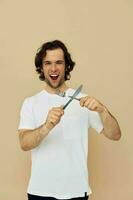 alegre hombre en un blanco camiseta con cuchillo con tenedor estilo de vida inalterado foto