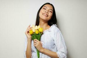 Charming young Asian woman with a bouquet of flowers smile close-up Lifestyle unaltered photo