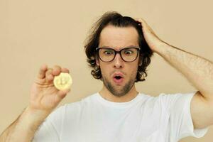 Attractive man in a white T-shirt with Bitcoin cryptocurrency isolated background photo