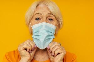 Photo of retired old lady happy lifestyle medical mask yellow background