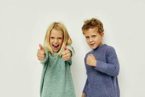 Little boy and girl gesticulate with their hands together childhood unaltered photo