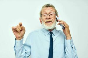 old man telephone communication glasses official light background photo