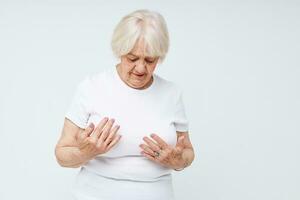 Photo of retired old lady in a white t-shirt light background