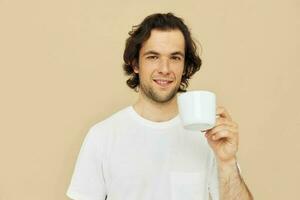 Cheerful man with a white mug in his hands emotions posing isolated background photo