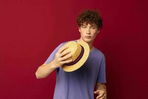 young guy fashion posing hand gestures stylish hat red background unaltered photo