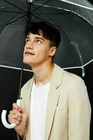 handsome man open transparent umbrella dark background photo