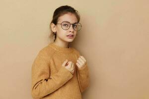 Portrait of happy smiling child girl with glasses emotions gesture hands Lifestyle unaltered photo