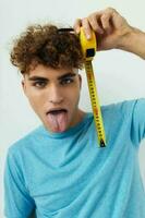 handsome young man emotions grimace measuring tape Lifestyle unaltered photo