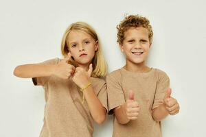 Boy and girl gesticulate with their hands together childhood unaltered photo