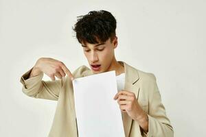 portrait of a young man posing with a notepad in a suit isolated background unaltered photo