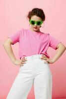 Young woman Youth clothing green sunglasses posing modern style pink background photo