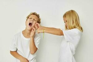 Little boy and girl in white T-shirts are standing next to Lifestyle unaltered photo