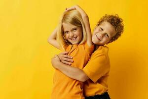 picture of positive boy and girl cuddling fashion childhood entertainment isolated background photo