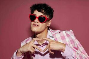 Photo of romantic young boyfriend sunglasses pink blazer fashion elegant style pink background unaltered