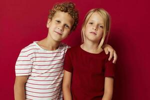 Portrait of cute children good mood standing next to posing on colored background photo