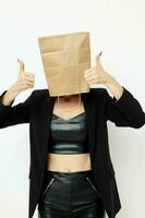 beautiful woman in a leather suit black jacket with a bag on his head isolated background photo