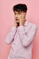 portrait of a young man posing fashion pink shirt modern style isolated background unaltered photo