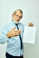 Portrait of happy senior man work office blank sheet of paper light background photo