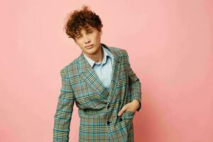 portrait of a young curly man gesturing with his hands emotions checkered jacket isolated background unaltered photo
