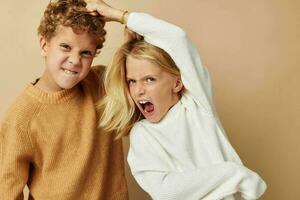 Photo of two children standing next to posing emotions isolated background