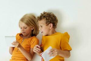 picture of positive boy and girl drawing fun games with notepad childhood lifestyle unaltered photo