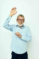 Senior grey-haired man in shirt and glasses posing emotions isolated background photo