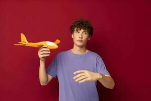 cute teen with toy airplane entertainment isolated background unaltered photo