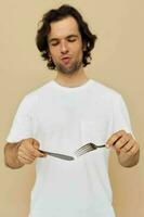 Cheerful man cutlery in hand posing isolated background photo