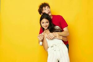 young boy and girl Friendship posing hugs together yellow background unaltered photo