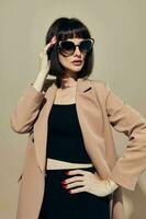 portrait of a woman in a beige jacket elegant style sunglasses Lifestyle unaltered photo