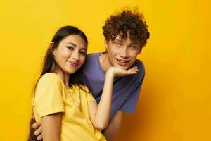 portrait of a man and a woman casual clothes posing emotions antics yellow background unaltered photo