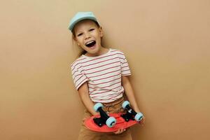 pretty young girl skateboard in hand posing baby clothes fun isolated background photo