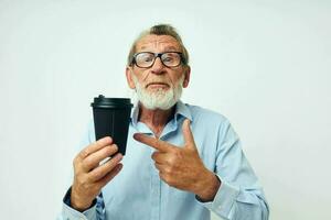 Photo of retired old man with glasses and shirts disposable glass isolated background