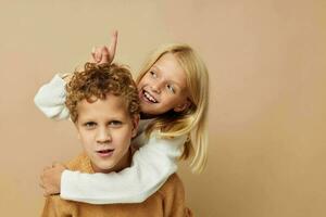 Boy and girl standing next to posing emotions Lifestyle unaltered photo