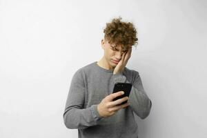 handsome young man with a phone in hand communication isolated background photo