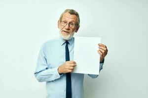 Portrait elderly man holding documents with a sheet of paper cropped view photo