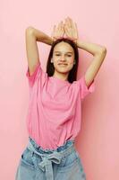 young beautiful woman in a pink t-shirt casual clothes pink background photo