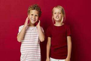 picture of positive boy and girl fun childhood entertainment on colored background photo