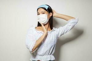 pretty brunette two medical masks on the head protection isolated background unaltered photo