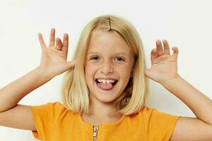 cheerful girl in a yellow t-shirt posing emotions light background photo